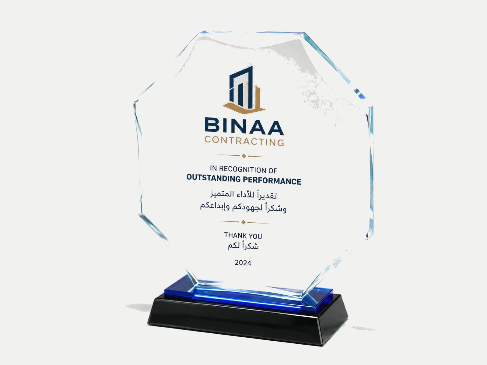 An eight-sided clear crystal on a black base, printed with a logo and citation.