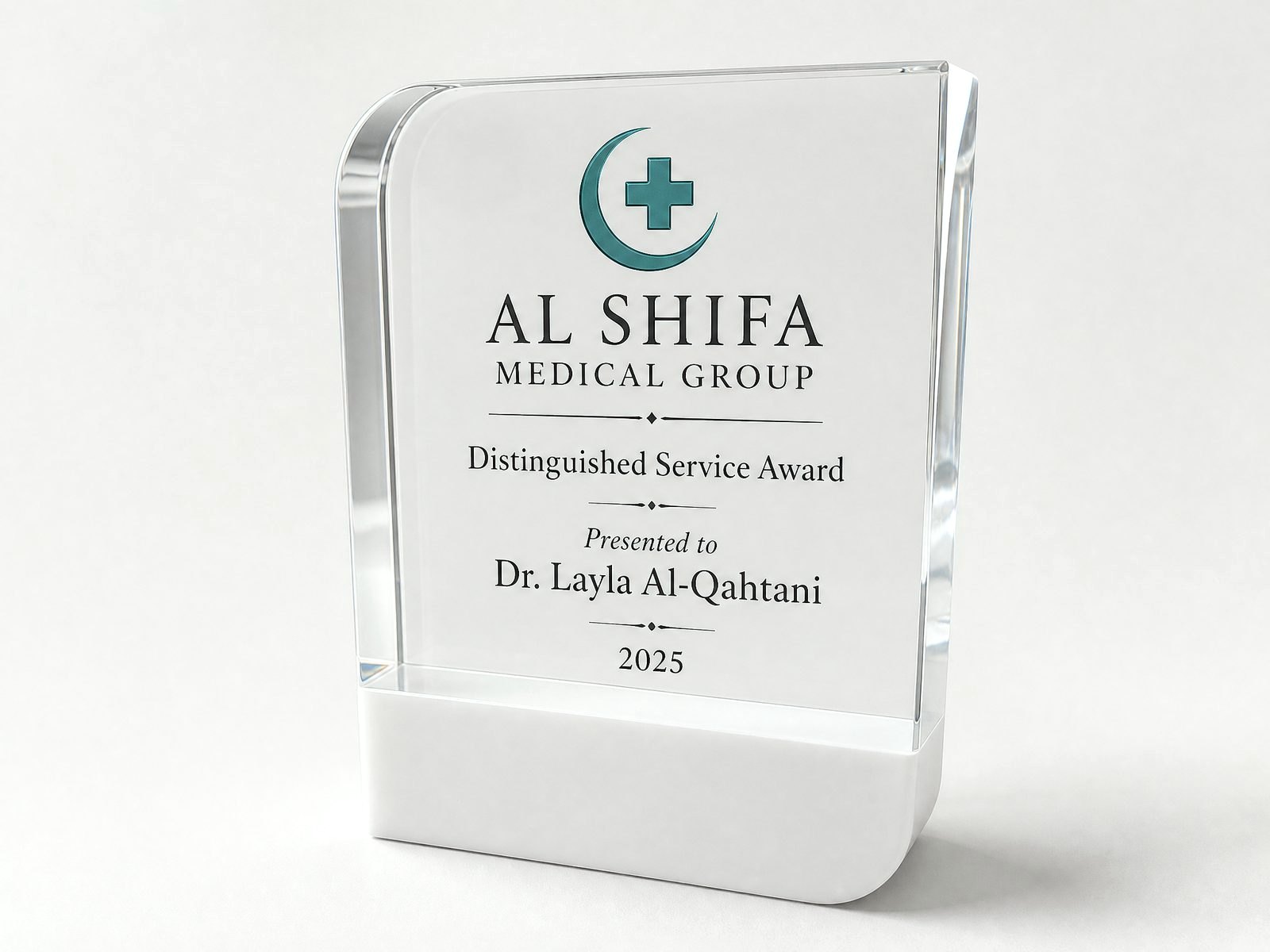 A clear crystal with soft square edges, printed with a logo and citation.