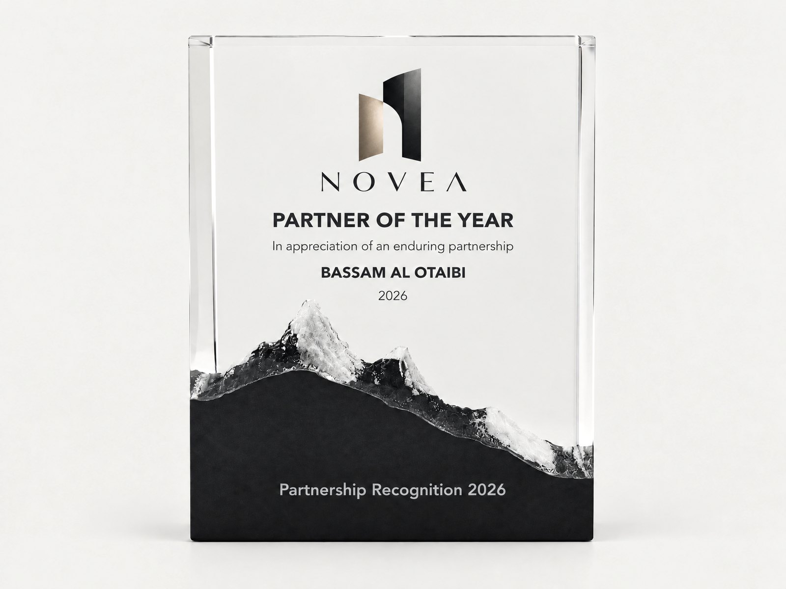 A crystal block with a frosted mountain range rising from a black base.